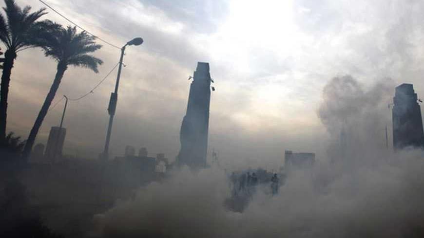 Tear gas fired by riot police is seen during clashes with protesters opposing Egyptian President Mursi along Qasr Al Nil bridge, which leads to Tahrir Square in Cairo January 27, 2013. Police fired teargas at dozens of stone-throwing protesters in Cairo on Sunday in a fourth day of street clashes that have killed at least 42 people and compounded the challenges facing President Mohamed Mursi. REUTERS/Amr Abdallah Dalsh (EGYPT - Tags: POLITICS CIVIL UNREST) - RTR3D1T3