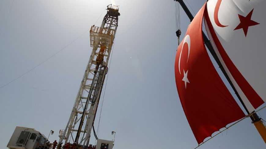 Turkish and Turkish Cypriot flags wave next to a drilling tower 25 km (16 miles) from Famagusta April 26, 2012. Turkish Cypriot Leader Dervis Eroglu and Turkey's Energy Minister Taner Yildiz attended a ceremony marking the start of joint gas and oil exploration works in northern Cyprus between Turkey's state-owned energy company TPAO and the Turkish-Cypriot administration. REUTERS/Umit Bektas (CYPRUS - Tags: POLITICS ENERGY BUSINESS)