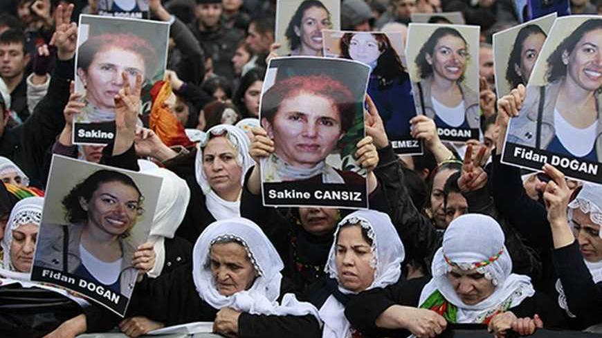 Pro-Kurdish demonstrators march with pictures of slain Kurdish activists Sakine Cansiz and Fidan Dogan during a protest at the Ataturk International Airport in Istanbul January 16, 2013. Three female Kurdish activists, including a founding member of the PKK rebel group, were found shot dead in Paris on Thursday, in execution-style killings condemned by Turkish politicians trying to broker a peace deal. REUTERS/Osman Orsal (TURKEY - Tags: POLITICS CIVIL UNREST)