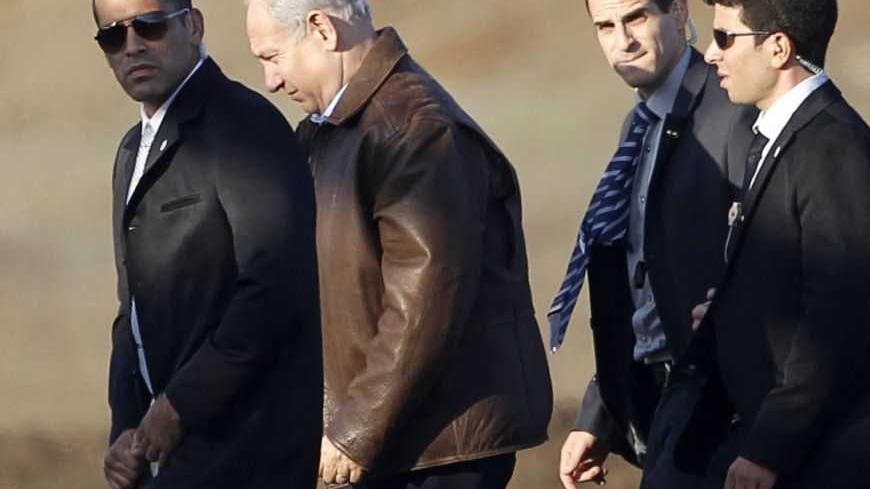 Israel's Prime Minister Benjamin Netanyahu (2nd L) walks towards a helicopter at the conclusion of his visit in the Israeli-occupied Golan Heights November 14, 2012. Syrian President Bashar al-Assad's forces are faltering against rebels, some of whom are dug in on the eastern foothills of the Golan Heights, Israel said on Wednesday. The violence near the Golan has jarred the Jewish state, which this week twice shot back after stray Syrian fire hit its side - the old foes' first armed engagement over the str