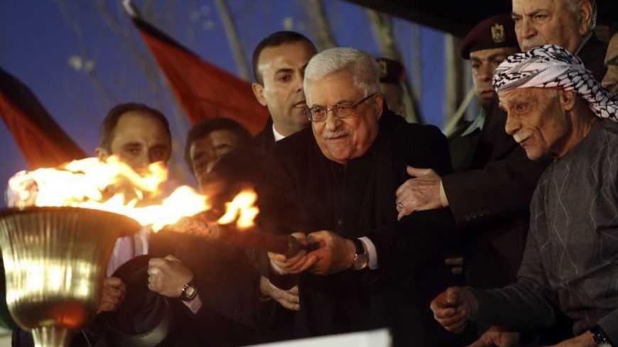 Palestinian President Mahmoud Abbas lights a torch during a rally marking the 48th anniversary of the founding of the Fatah movement in the West Bank city of Ramallah December 31, 2012. REUTERS/Mohamad Torokman (WEST BANK - Tags: ANNIVERSARY POLITICS) - RTR3C0A1