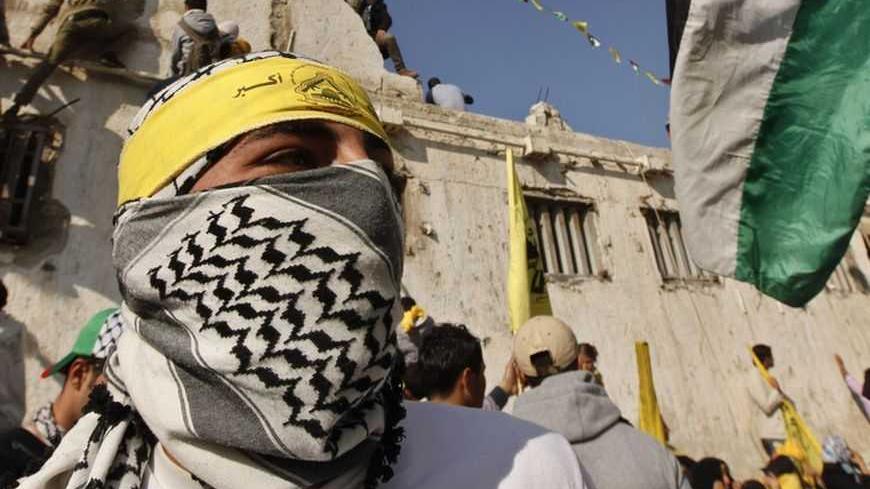 A masked Palestinian wearing a Fatah headband takes part in a rally marking the 48th anniversary of the founding of the Fatah movement, in Gaza City January 4, 2013. Hundreds of thousands of Palestinians joined a rare rally staged by President Mahmoud Abbas's Fatah group in Gaza on Friday, as tensions ease with rival Hamas Islamists ruling the enclave since 2007. REUTERS/Mohammed Salem (GAZA - Tags: POLITICS ANNIVERSARY TPX IMAGES OF THE DAY) - RTR3C3IA