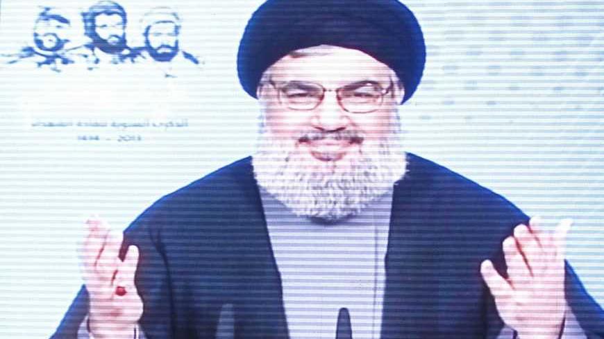 Lebanon's Hezbollah leader Sayyed Hassan Nasrallah is seen on a screen as he speaks to his supporters during a rally to commemorate Martyrs' Day in Beirut, February 16, 2013. REUTERS/Sharif Karim (LEBANON - Tags: POLITICS) - RTR3DVBX