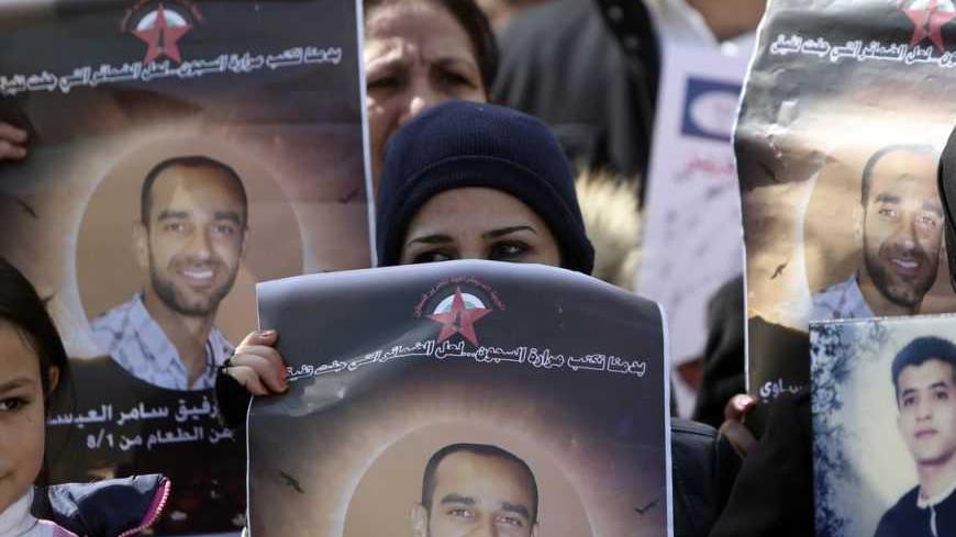 Palestinians hold placards depicting prisoner Samer al-Issawi, who has been on hunger strike for 209 days, during a protest in the West Bank city of Ramallah, calling for the release of Palestinian prisoners from Israeli jails, February 17, 2013. The European Union on Saturday called on Israel to improve conditions for Palestinians in its jails, and a Palestinian minister said there would be rallies this week to support hunger striking prisoners. Nearly 5,000 Palestinians are held in Israeli jails, many cha