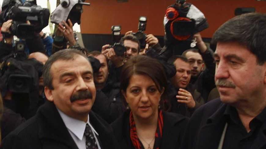 Pro-Kurdish politicians Sirri Sureyya Onder (3rd R), Pelvin Buldan (2nd R) and Altan Tan (R), are surrounded by media members before leaving for Imrali island in Istanbul February 23, 2013. A delegation of pro-Kurdish politicians left for Imrali island to meet with imprisoned Kurdistan Workers Party (PKK) leader Abdullah Ocalan. Turkey launched tentative negotiations with PKK leader Ocalan in his jail on Imrali island near Istanbul in October, drawing up a framework to end a conflict which has killed more t
