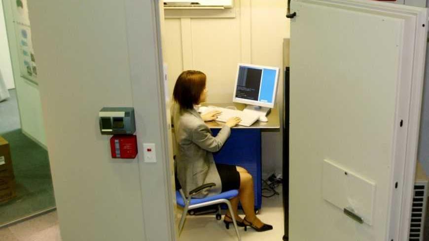 An employee of Japan's biggest security service firm Secom Co Ltd uses
a computer inside the company's "Secom computer protection safe" which
protects computer servers not only from cyberattacks but also from
actual illegal intruders and physical damage occuring from
environmental factors, in Tokyo March 12, 2003. The fire-proof safe
measuring 2.58 metres (8.46 feet) in width, 2.84 metres (9.31 feet) in
height and 3.04 metres (9.97 feet) in depth carries a price tag
starting from 9.8 million yen ($83