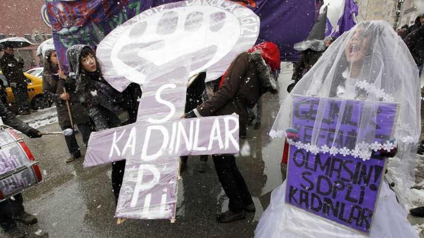 Women shout slogans as they march through central Ankara to commemorate International Women's Day March 8, 2011. The banner on the right reads "Do not let our wedding dresses to be our shrouds" REUTERS/Umit Bektas (TURKEY - Tags: POLITICS CIVIL UNREST) - RTR2JLUF