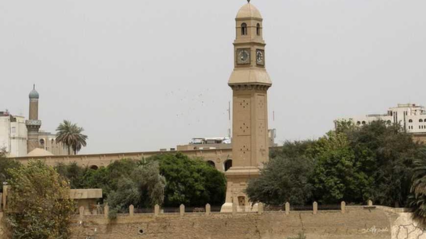 The clock tower of Qushla is seen at noon in central Baghdad April 2, 2012. Qushla, or the Ottoman government headquarters on the bank of the Tigris River in Baghdad's Rusafa side is one of the city's important archaeological sites and tourist attractions. REUTERS/Thaier al-Sudani (IRAQ - Tags: SOCIETY) - RTR308PW