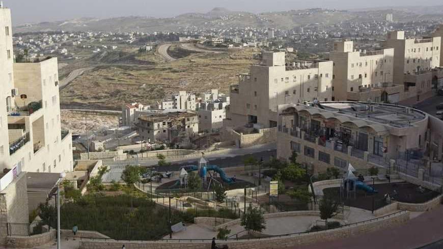 A general view shows Palestinian villages (rear) around a Jewish settlement near Jerusalem known to Israelis as Har Homa and to Palestinians as Jabal Abu Ghneim April 25, 2012. Har Homa is a terraced suburb of neat, white-stone apartments housing 13,000 Israelis that overlooks the biblical town of Bethlehem. Of all the obstacles blocking the way to peace between the Palestinians and Israelis, the status of Jerusalem is arguably the most intractable. Picture taken April 25, 2012. To match insight PALESTINIAN