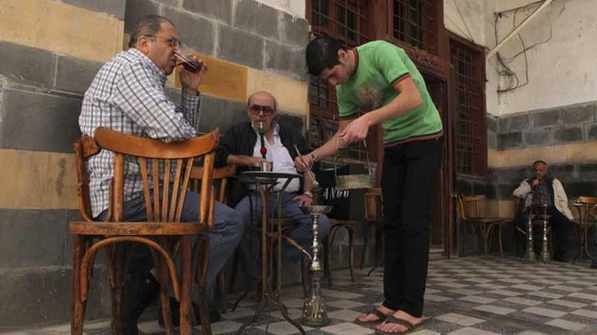 Men drink tea and smoke water pipe at a cafe in the old city of Damascus November 8, 2012. REUTERS/Muzaffar Salman  (SYRIA - Tags: SOCIETY) - RTR3A600
