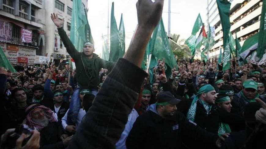 Palestinians wave Hamas flags during a rally in the West Bank city of Nablus, marking the 25th anniversary of the founding of Hamas December 13, 2012. It was the first rally Western-backed Palestinian President Mahmoud Abbas allowed to take place in the West Bank since 2007, when his Islamist rivals Hamas seized control of the Gaza Strip. REUTERS/Muammar Awad (WEST BANK - Tags: POLITICS ANNIVERSARY) - RTR3BJF8