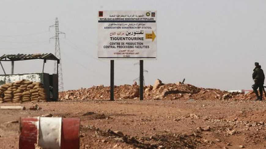 An Algerian soldier stands at a checkpoint near a road sign indicating 10 km (6 miles) to a gas installation in Tigantourine (sometimes spelled Tiguentourine), the site where Islamist militants have been holding foreigners hostage according to the Algerian interior ministry, in Amena January 19, 2013. More than 20 foreigners were captive or missing inside the desert gas plant on Saturday, nearly two days after the Algerian army launched an assault to free them that saw many hostages killed. The standoff bet