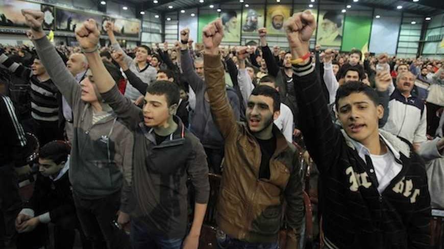 Supporters of Lebanon's Hezbollah leader Sayyed Hassan Nasrallah shout slogans during a rally to commemorate the birth of Prophet Mohammad in Beirut's suburbs, January 25, 2013. REUTERS/Sharif Karim (LEBANON - Tags: POLITICS) - RTR3CY5C
