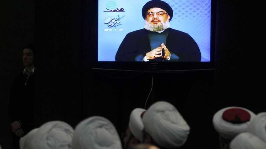Lebanese Shi'ite and Sunni Muslim sheikhs listen to Lebanon's Hezbollah leader Sayyed Hassan Nasrallah during a rally to commemorate the birth of Prophet Mohammad in Beirut's suburbs, January 25, 2013.  REUTERS/Sharif Karim (LEBANON - Tags: POLITICS) - RTR3CY5E