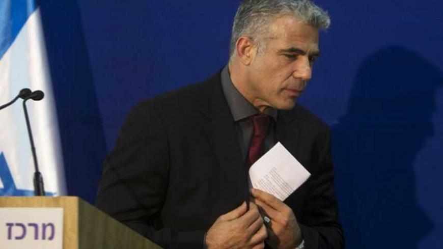 Yair Lapid, leader of the Yesh Atid (There's a Future) party, leaves the podium after delivering a statement to the media, following his meeting with Israel's President Shimon Peres (unseen) in Jerusalem January 30, 2013. Peres on Wednesday began consultations with political parties over the formation of a new coalition and appears certain to pick incumbent Prime Minister Benjamin Netanyahu to assemble it. Lapid's new centrist party stormed to second place in last week's election by winning 19 seats. REUTER