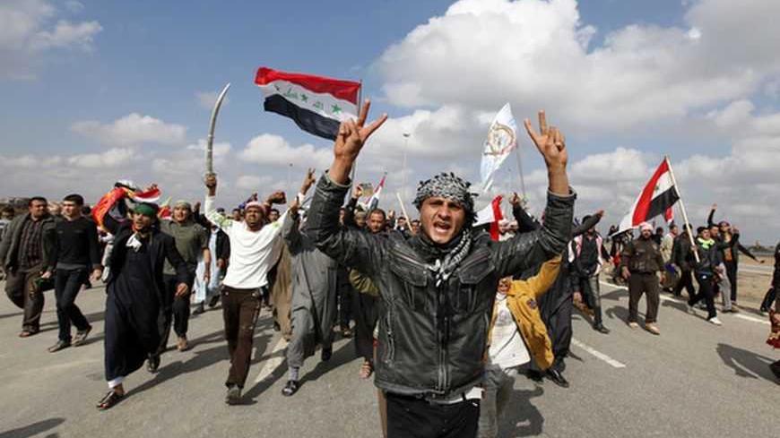 Iraqi Sunni Muslims shout slogans during an anti-government demonstration in Falluja, 50 km (30 miles) west of Baghdad,February 1, 2013. Chanting "No" to Iraqi Prime Minister Nuri al-Maliki, tens of thousands of Sunni Muslims protested after Friday prayers in huge rallies against the Shi'ite premier that are raising the spectre of renewed sectarian unrest. REUTERS/Thaier Al-Sudani (IRAQ CONFLICT - Tags: POLITICS CIVIL UNREST TPX IMAGES OF THE DAY) - RTR3D8BA