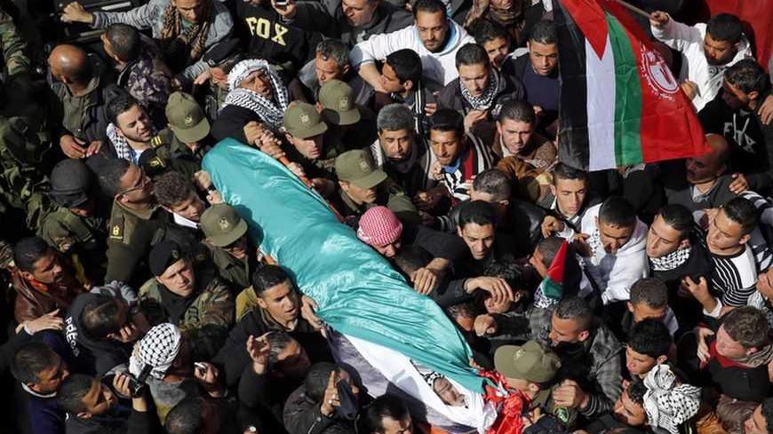 Palestinians carry the body of Arafat Jaradat as it arrives at his home before his funeral in the West Bank village of Se'eer near Hebron February 25, 2013. Israeli soldiers turned out in force on Monday for the funeral of Jaradat, who was arrested just one week ago for throwing stones at Israeli cars in the West Bank. Jaradat's death in an Israeli jail on Saturday and a hunger strike by four other prisoners have raised tension in the West Bank, where stone-throwers have clashed repeatedly with Israeli sold