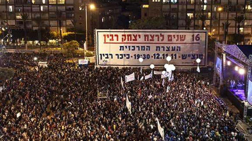 A general view shows Rabin Square during a mass rally marking the 16th anniversary of the assassination of then-Israeli prime minister Yitzhak Rabin, in Tel Aviv November 12, 2011. Israel on Saturday marked the 16th anniversary of Rabin's assassination by an ultra-nationalist Jew. The banner reads, "16 years since the assassination of Yitzhak Rabin". REUTERS/ Nir Elias (ISRAEL - Tags: ANNIVERSARY POLITICS) - RTR2TXTH