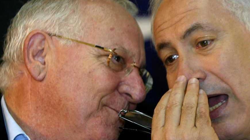Israeli Likud chairman Benjamin Netanyahu (R) speaks to Reuven Rivlin, Knesset speaker, as they attend a pre-election gathering in the town of Petah Tikva, near Tel Aviv, March 15, 2006. Israel will hold general elections on March 28. REUTERS/Gil Cohen Magen - RTR177A1