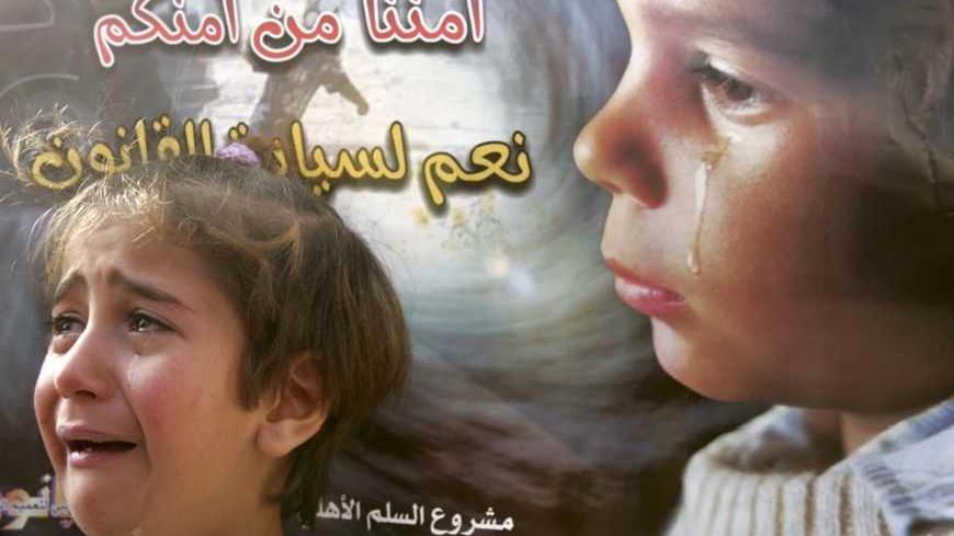 A Palestinian girl cries as she attends a rally protesting Monday's killing of the three sons of a Palestinian intelligence chief loyal to President Mahmous Abbas in Gaza December 13, 2006 in front of a poster depicting a schoolmate of the slain children. Tensions and violence have spiralled in Gaza and the occupied West Bank between Hamas and the rival Fatah faction of Abbas after attempts to form a national unity government failed.  REUTERS/Mohammed Salem (GAZA) - RTR1KCOZ