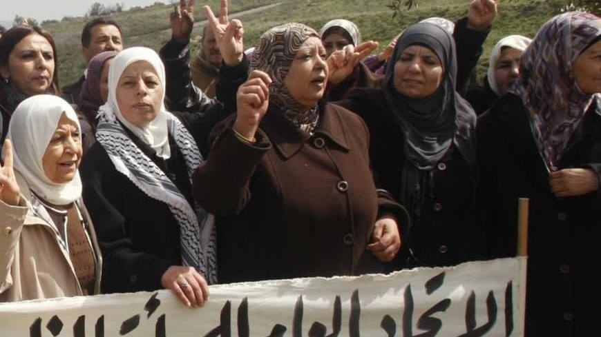 Palestinians gesture during a demonstration to mark International Women's Day in the West Bank village of Burin near Nablus March 8, 2011. The banner reads in Arabic: "The general union of Palestinian women marks Women's Day. No to occupation. Yes to the right of return (for refugees). Yes for unity" (refering to the split between Hamas and the Fatah movement). REUTERS/Abed Omar Qusini (WEST BANK - Tags: POLITICS CIVIL UNREST) - RTR2JM4M