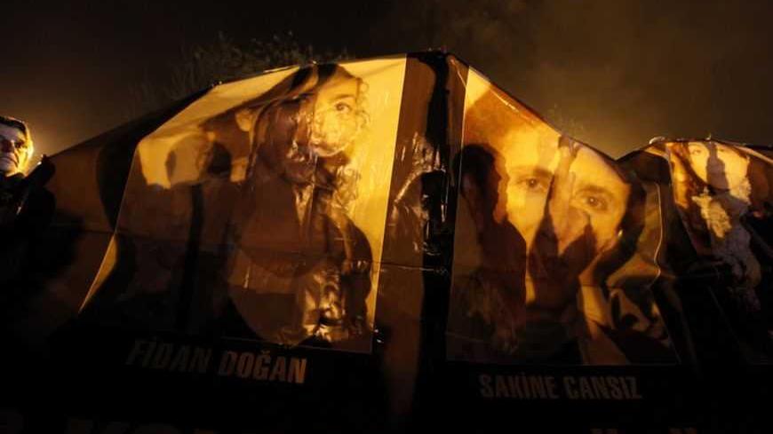 Kurdish demonstrators hold up pictures of the three Kurdish activists shot in Paris, as they wait for the ambulances carrying their bodies in Diyarbakir, the largest city in Turkey's mainly Kurdish southeast, January 16, 2013. The bodies of the activists, including that of Kurdistan Workers Party (PKK) co-founder Sakine Cansiz, arrived by plane on Wednesday evening in Diyarbakir ahead of a funeral ceremony on Thursday. REUTERS/Umit Bektas (TURKEY - Tags: CIVIL UNREST POLITICS OBITUARY TPX IMAGES OF THE DAY)