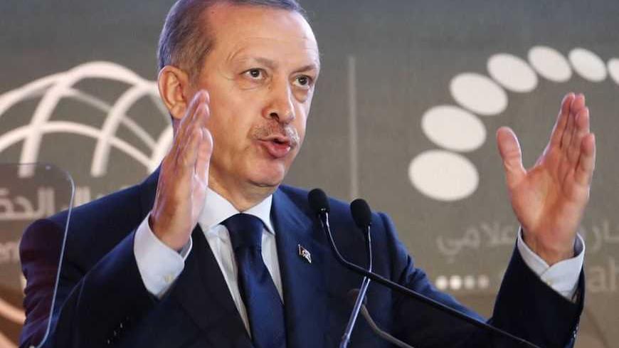 Turkish Prime Minister Tayyip Erdogan talks during the opening ceremony of government communication forum in Sharjah, United Arab Emirates February 24, 2013. REUTERS/Ahmed Jadallah (UNITED ARAB EMIRATES - Tags: POLITICS SCIENCE TECHNOLOGY) - RTR3E7DY