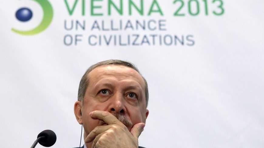 Turkey's Prime Minister Tayyip Erdogan listens during a news conference after the opening session of the fifth United Nations Alliance of Civilizations (UNAOC) Forum in Vienna February 27, 2013. REUTERS/Heinz-Peter Bader (AUSTRIA - Tags: POLITICS) - RTR3ECGF