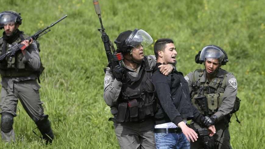 Israeli border police officers detain a Palestinian suspected of throwing stones during clashes outside Israel's Ofer military prison near the West Bank city of Ramallah February 28, 2013. The death of a Palestinian prisoner in disputed circumstances in an Israeli jail on Saturday, together with a hunger strike by four other Palestinian inmates, have touched off violent protests over the past several weeks outside the prison and in West Bank towns. REUTERS/Mohamad Torokman (WEST BANK - Tags: POLITICS CIVIL 