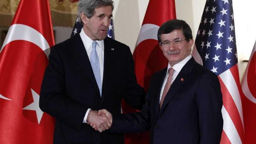 U.S. Secretary of State John Kerry (L) shakes hands with Turkish Foreign Minister Ahmet Davutoglu after their news conference at Ankara Palas in Ankara March 1, 2013. REUTERS/Umit Bektas (TURKEY - Tags: POLITICS) - RTR3EG52