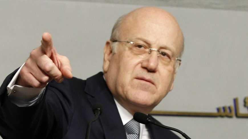 Lebanon's Prime Minister Najib Mikati gestures before delivering a news conference at the Grand Serail, the government headquarters in Beirut, March 22, 2013. Lebanon's Prime Minister Najib Mikati announced his resignation on Friday after Shi'ite group Hezbollah and its allies blocked the creation of a body to supervise parliamentary elections and opposed extending the term of a senior security official. REUTERS/Mohamed Azakir (LEBANON - Tags: POLITICS) - RTR3FCDT