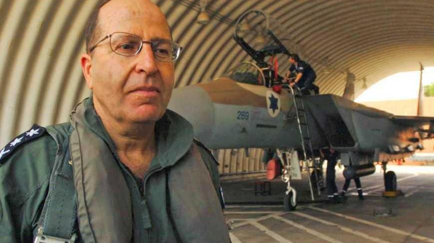 Israeli army Chief of staff Moshe Yaalon stands in front of a fighter jet at Natzarym air base in this handout photo.  Outgoing Israeli army Chief of Staff Moshe Yaalon stands in front a fighter jet at the Natzarym air base in Israel May 23, 2005 in this handout photo released by the Israeli Defence Force press office. REUTERS/IDF/Handout - RTRC6I8