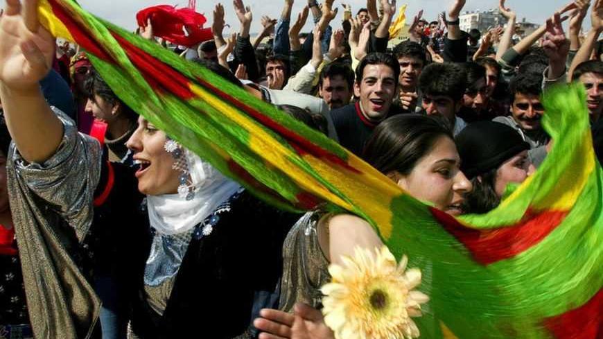 Kurdish women and men dance during the Nevruz celebrations in the southern Turkish city of Mersin March 21, 2003. Nevruz, a combination of Persian words Nev (New) and Ruz (Day), which is celebrated by the Kurds in Central Asia, and Anatolia and by Iranians can be defined as "the New Day of the New Year". REUTERS/Yves Herman PP03030048     Pictures of the month March 2003  HRM   also see GF2DWFLPITAA - RTRKREN