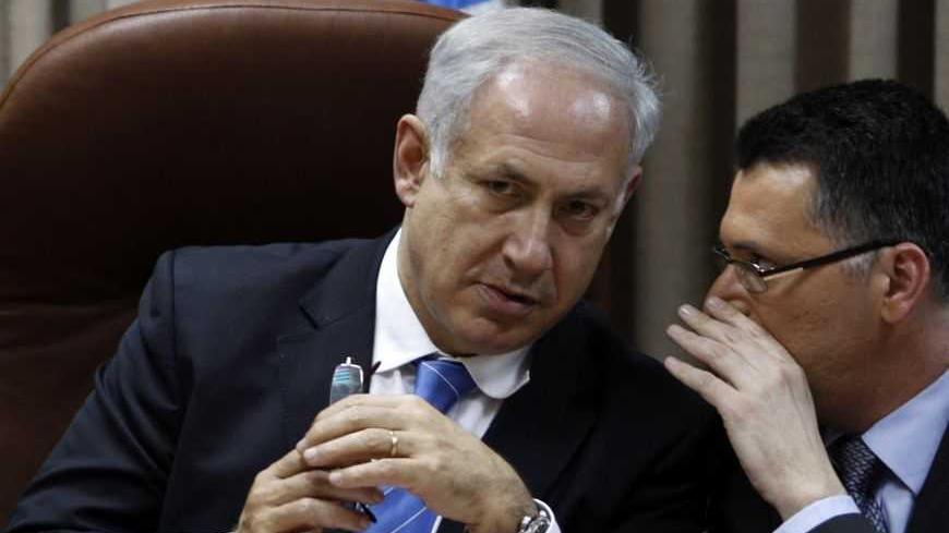 Israel's Likud party leader Benjamin Netanyahu listens to Gideon Sa'ar, a member of the Knesset, during a party meeting at the Israeli parliament in Jerusalem February 11, 2009. Israel headed for political gridlock on Wednesday with both Foreign Minister Tzipi Livni's centrist Kadima party and Netanyahu's right-wing Likud party declaring victory in an election that left the prospect of Israel and the Palestinians making peace as distant as ever. REUTERS/Baz Ratner (JERUSALEM) - RTXBIAC