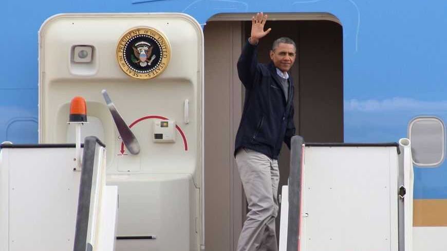 U.S. President Barack Obama waves as he boards Air Force One at the airport in Amman March 23, 2013. Obama marvelled at the sights of Jordanís ancient city of Petra on Saturday as he wrapped up a four-day Middle East tour by setting aside weighty diplomatic matters and playing tourist for a day. REUTERS/Majed Jaber    (JORDAN - Tags: POLITICS) - RTXXUHD