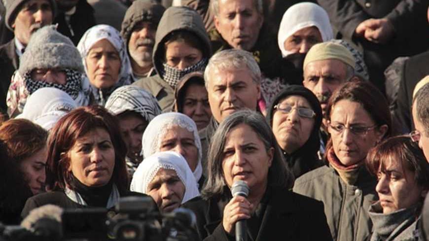 Gultan Kisanak (C), co-leader of Turkey's pro-Kurdish opposition Peace and Democracy Party (BDP), makes a speech on the killing of three female Kurdish activist during a demonstration in Diyarbakir, southeastern Turkey, January 10, 2013. Three female Kurdish activists including a founding member of the PKK rebel group were shot dead in Paris overnight in execution-style killings condemned by Turkish politicians trying to broker a peace deal. REUTERS/Sertac Kayar (TURKEY - Tags: POLITICS CIVIL UNREST) - RTR3