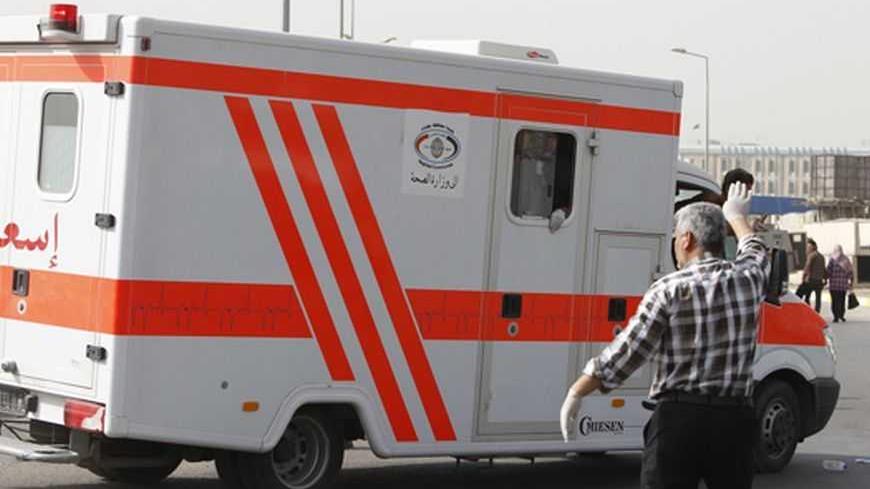 An Iraqi Red Crescent ambulance, transporting people injured in a bomb attack, travels to a hospital at Alawi district in Baghdad March 14, 2013. Co-ordinated blasts in the heart of the Iraqi capital Baghdad killed at least 21 people on Thursday, near the heavily fortified Green Zone, where several Western embassies are located, police and medics said. The explosions, which also wounded at least 50, took place in the Alawi district, close to the ministries of justice, foreign affairs and other government of