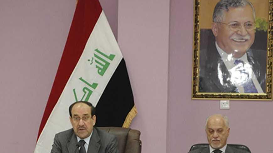 Iraqi Prime Minister Nuri al-Maliki (L) speaks next to Iraq's Deputy Prime Minister for Energy Hussain al-Shahristani during a meeting of the Council of Ministers in Kirkuk, 250 km (155 miles) north of Baghdad May 8, 2012. On top right hangs a picture of Iraq's President Jalal Talabani. REUTERS/Iraqi Prime Minister Media Office/Handout (IRAQ - Tags: POLITICS) FOR EDITORIAL USE ONLY. NOT FOR SALE FOR MARKETING OR ADVERTISING CAMPAIGNS. THIS IMAGE HAS BEEN SUPPLIED BY A THIRD PARTY. IT IS DISTRIBUTED, EXACTLY