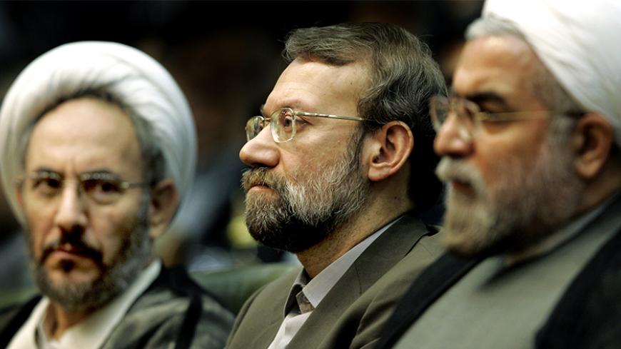 Iran's former Intelligence Minister Ali Younesi (L), chief nuclear negotiator Ali Larijani and former chief nuclear negotiator Hassan Rouhani (R) attend a conference on Iran's Nuclear Policies and Prospects in Tehran April 25, 2006. Larijani said on Tuesday his country would suspend its relations with the International Atomic Energy Agency (IAEA) if sanctions were imposed, as advocated by the United States. REUTERS/Raheb Homavandi - RTR1CS06