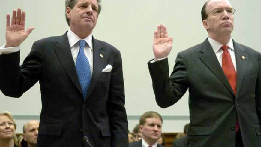 U.S. Ambassador Paul Bremer (L), former head of the Coalition Provisional Authority, and Stuart Bowen, the U.S. special inspector general for Iraq reconstruction, are sworn in at a hearing of the House Oversight and Government Reform Committee on the management of U.S. funds in Iraq, on Capitol Hill in Washington February 6, 2007.  REUTERS/Jonathan Ernst   (UNITED STATES) - RTR1M2AQ