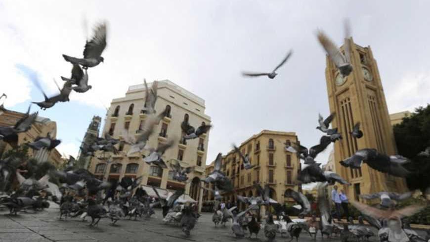 Pigeons fly in front of the parliament square in downtown Beirut October 25, 2012. The party capital of the Arab world, Beirut is a freewheeling city where Gulf Arabs, expatriates and Lebanese emigres fly in to enjoy its luxury hotels. But under the veneer of modernity lie sectarian demons coiled to strike. The car-bomb assassination last Friday of intelligence chief Wissam al-Hassan - an attack almost universally blamed on Syria and its local allies - brought the merry-go-round to a juddering halt. Gunmen 