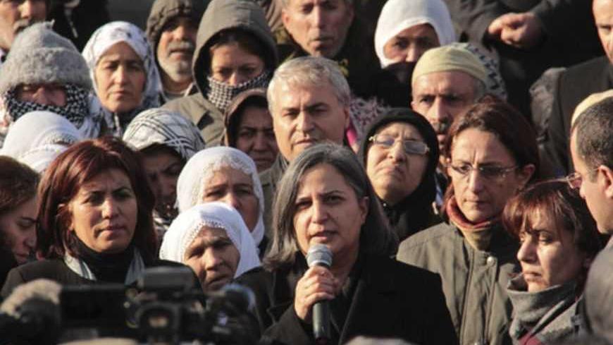 Gultan Kisanak (C), co-leader of Turkey's pro-Kurdish opposition Peace and Democracy Party (BDP), makes a speech on the killing of three female Kurdish activist during a demonstration in Diyarbakir, southeastern Turkey, January 10, 2013. Three female Kurdish activists including a founding member of the PKK rebel group were shot dead in Paris overnight in execution-style killings condemned by Turkish politicians trying to broker a peace deal. REUTERS/Sertac Kayar (TURKEY - Tags: POLITICS CIVIL UNREST) - RTR3