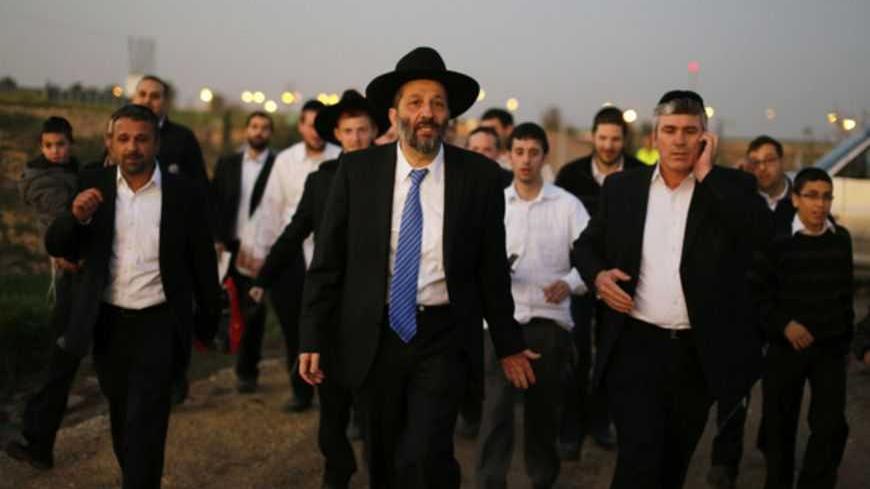 Aryeh Deri (C), leader of the ultra-Orthodox Shas party, attends an annual pilgrimage to the gravesite of Rabbi Yisrael Abuhatzeira, a Moroccan-born sage and kabbalist also known as the Baba Sali, in the southern town of Netivot January 14, 2013.  Powerful political players for years, Israel's ultra-Orthodox parties must now reckon with a new force ushered in by voters bent on stripping them of perks they have relied on for decades. Picture taken January 14, 2013. REUTERS/Amir Cohen (ISRAEL - Tags: POLITICS