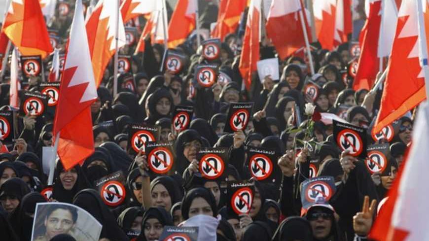 Protesters hold banners with sign "No U Turn" meaning "No Returning Back" and hold Bahraini flags as they participates in a rally organised by Bahrain's main opposition society Al Wefaq, in Budaiya west of Manama, Bahrain, February 6, 2013. REUTERS/Hamad I Mohammed (BAHRAIN - Tags: POLITICS CIVIL UNREST TPX IMAGES OF THE DAY) - RTR3DETO