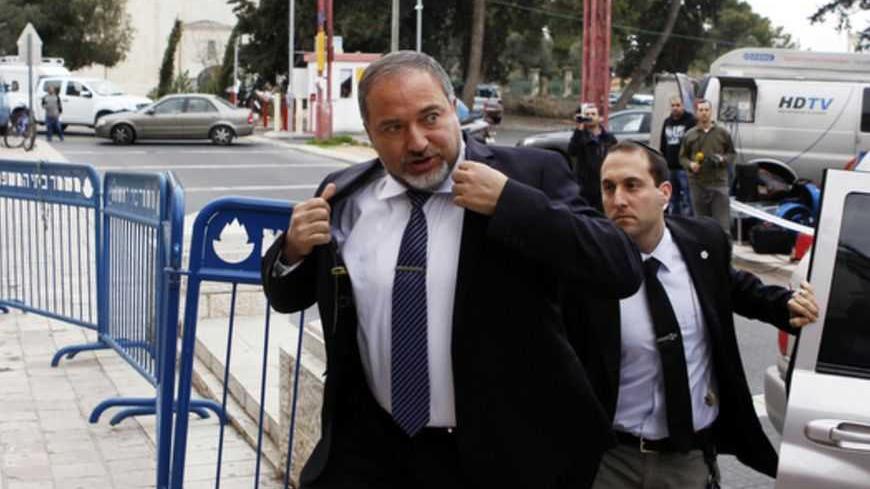 Avigdor Lieberman (C), former Israeli foreign minister, arrives at Jerusalem's magistrate court February 17, 2013. Lieberman's trial began in Jerusalem on Sunday and he pleaded not guilty to charges of fraud and breach of trust, allegations that prompted his resignation as foreign minister in December. REUTERS/Baz Ratner (JERUSALEM - Tags: POLITICS CRIME LAW) - RTR3DWQJ