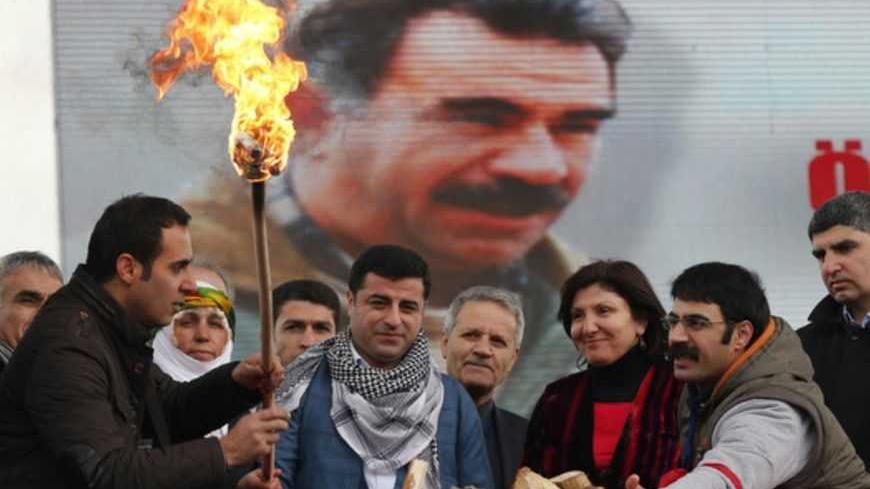Selahattin Demirtas (front C), co-chairman of the pro-Kurdish Peace and Democracy Party (BDP), lights a traditional Newroz fire during a rally to celebrate the spring festival of Newroz in Istanbul March 17, 2013. Kurdish parliamentarians set off by boat on Monday to visit Kurdish militant leader Abdullah Ocalan in his island prison where they expected him to summon his fighters to cease fire and leave Turkey to help end a 28-year-old insurgency. The conflict has been a major source of instability in Turkey