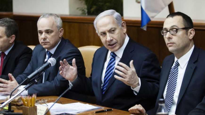 Israeli Prime Minister Benjamin Netanyahu (C) gestures as he speaks during the first cabinet meeting of the 33rd Israeli government, in Jerusalem March 18, 2013. Netanyahu's new governing coalition took office after a parliamentary vote on Monday with powerful roles reserved for supporters of settlers in occupied territory. REUTERS/David Vaaknin/Pool (JERUSALEM - Tags: POLITICS) - RTR3F5ZH
