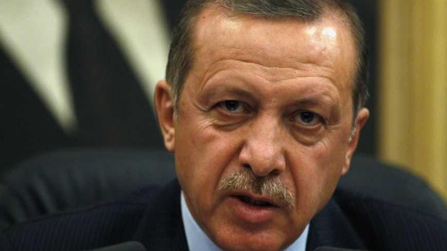 Turkey's Prime Minister Recep Tayyip Erdogan addresses the media before his flight to Denmark for an official visit at Esenboga Airport in Ankara March 19, 2013. REUTERS/Umit Bektas (TURKEY - Tags: POLITICS HEADSHOT) - RTR3F72K