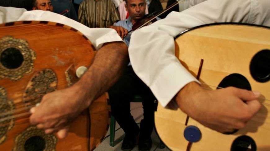 Palestinian musicians play their musical instruments in Gaza city August 16, 2005 they prepare for celebrations marking Israel's pullout from the Gaza Strip. Israeli security forces poured into the largest Gaza settlement on Tuesday, clashing with protesters defying orders for Jews to leave the occupied territory by midnight or be forcibly evicted. REUTERS/Ahmed Jadallah  AJ/JJ - RTRKP9D
