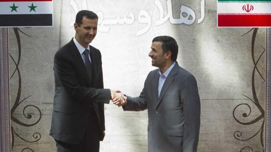 EDITORS' NOTE: Reuters and other foreign media are subject to Iranian restrictions on their ability to report, film or take pictures in Tehran. 

Iranian President Mahmoud Ahmadinejad (R) shakes hands with his Syrian counterpart Bashar al-Assad during an official welcoming ceremony in Tehran October 2, 2010. REUTERS/Morteza Nikoubazl (IRAN - Tags: POLITICS) - RTXSXO5